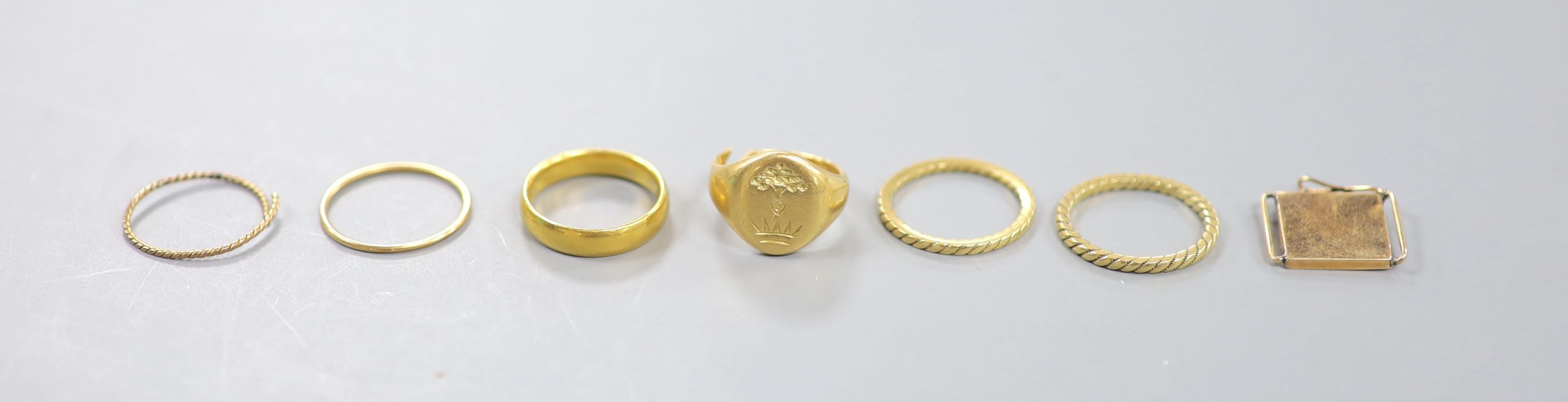 A George V 22ct gold wedding band, 5 grams, a yellow metal signet ring(cut) 8.2 grams and five other items.